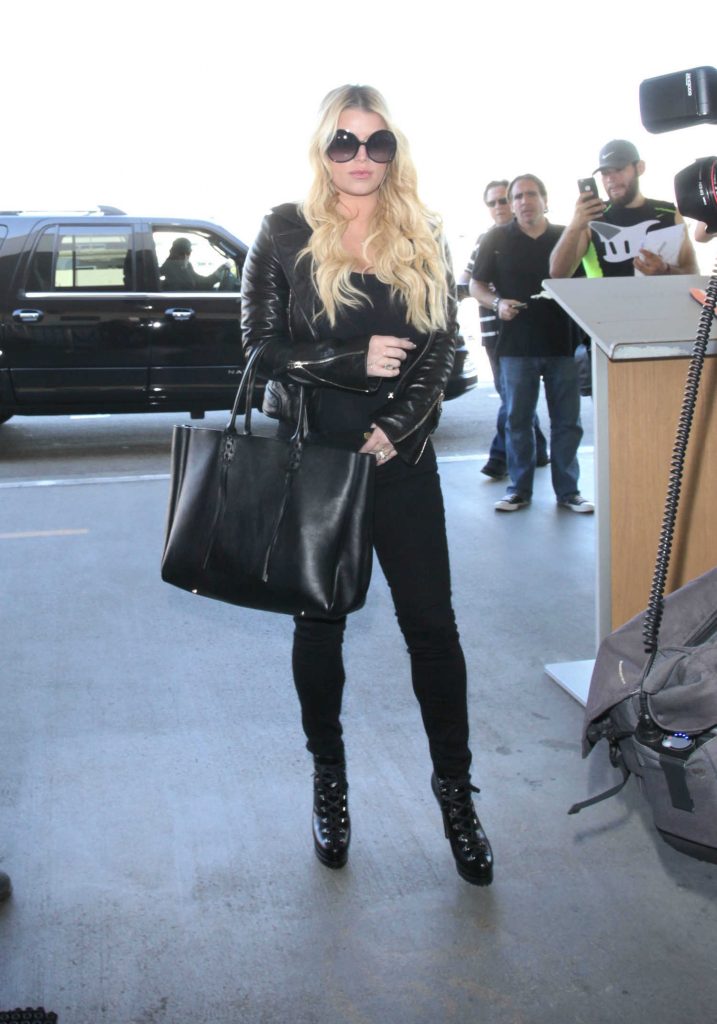 Simpson Arrives at JFK Airport in NYC With Her Husband Eric Johnson-1