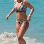 Olivia Buckland Wears a Striped Bikini on the Beach in Barbados