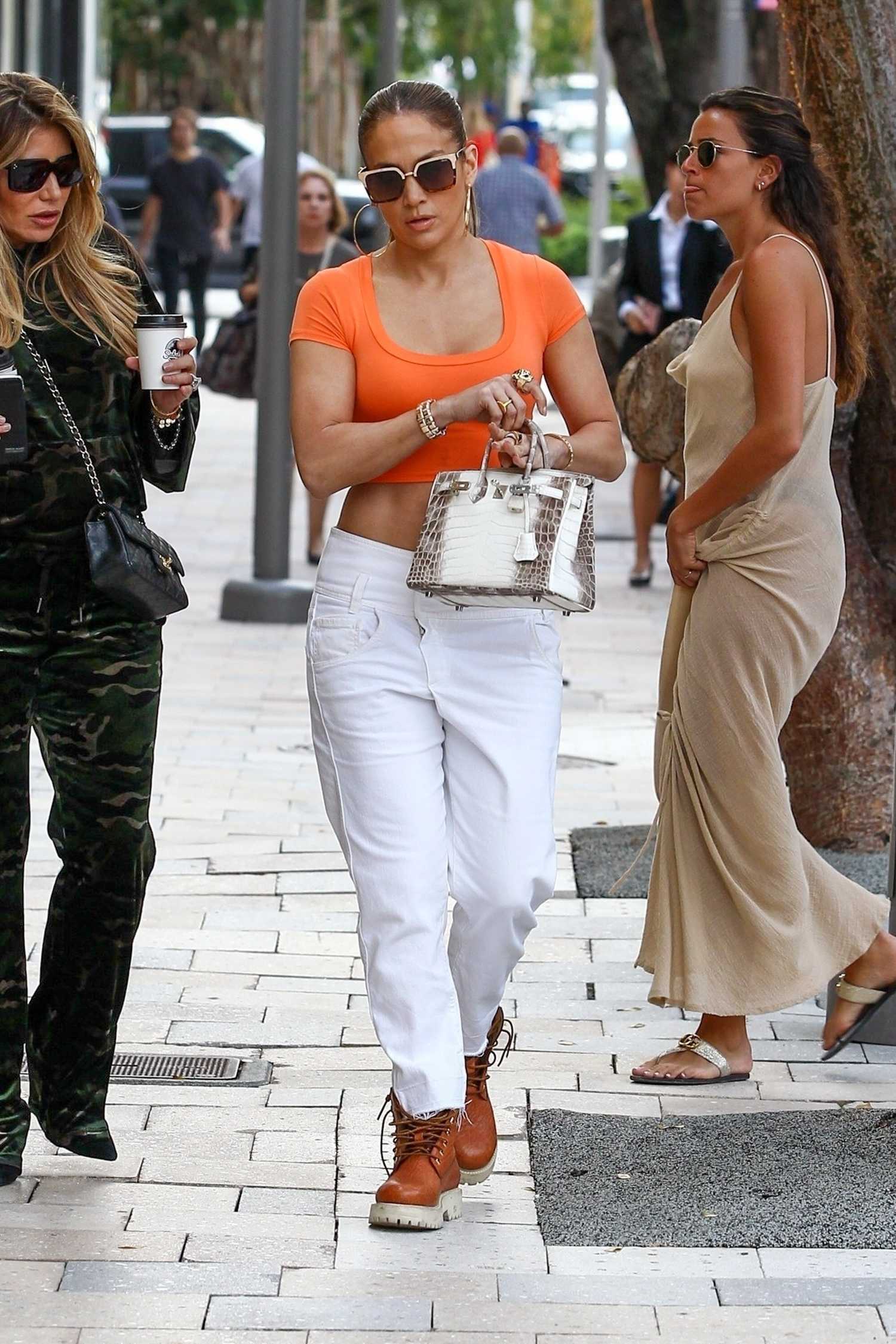 Jennifer Lopez in an Orange Top Out for Shopping in Miami – Celeb Donut