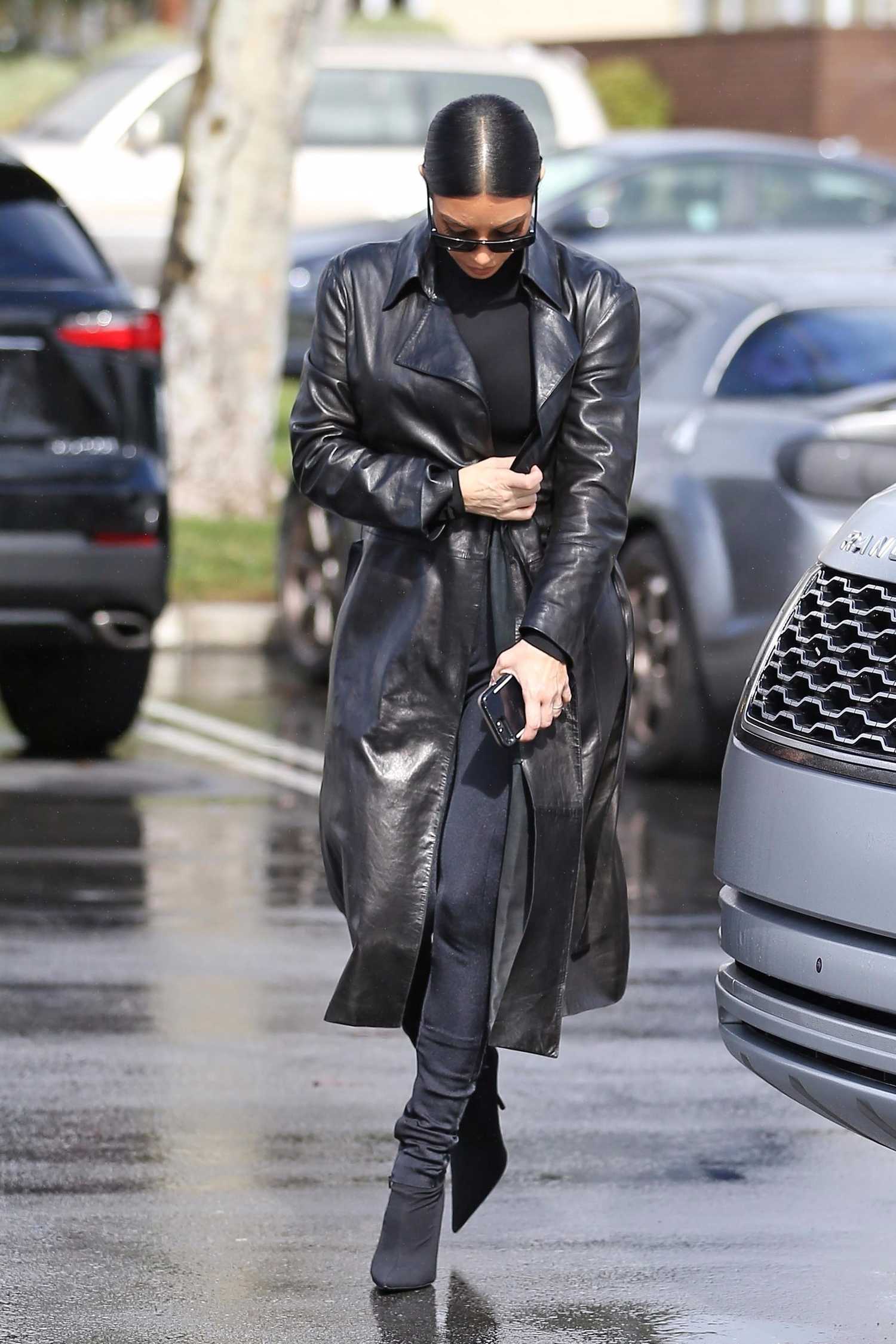 Kim Kardashian. in a Black Leather Trench Coat Was Spotted Out in Los Angel...