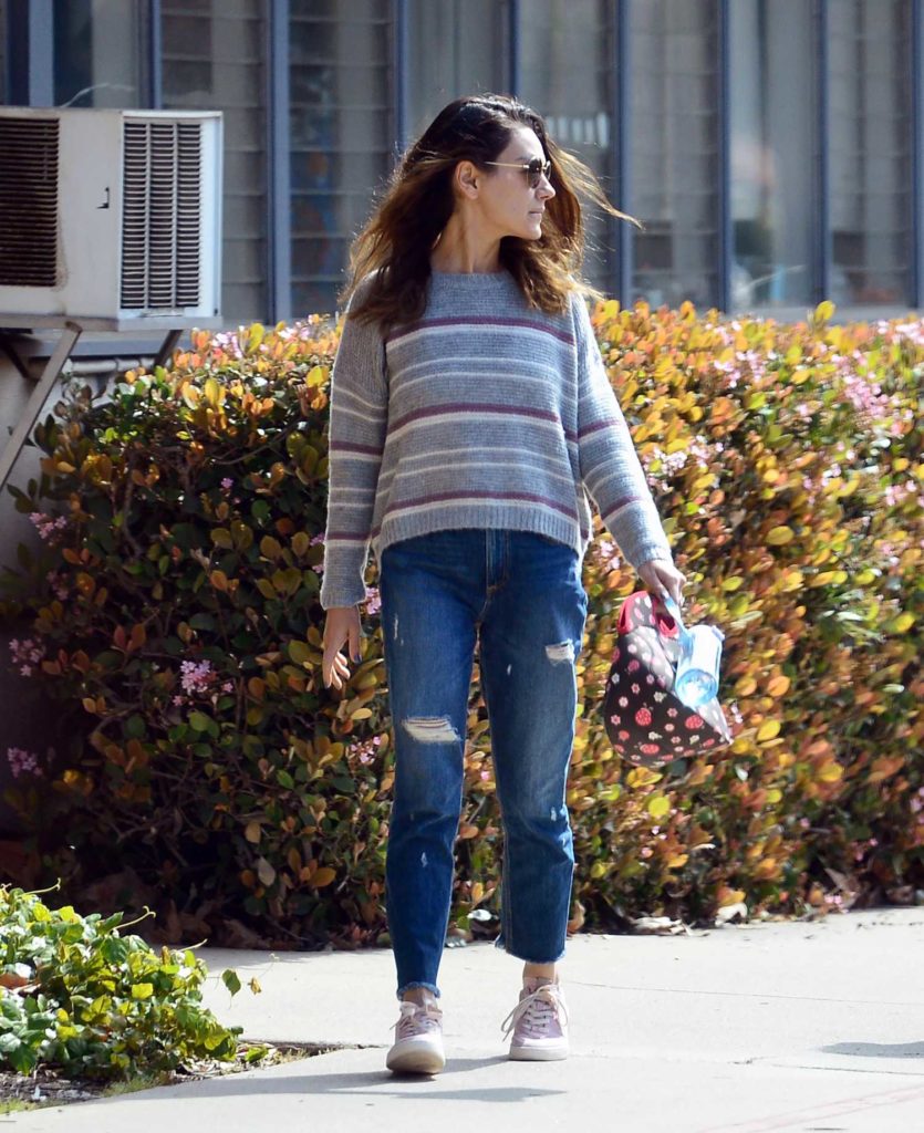 Mila Kunis in a Blue Ripped Jeans