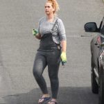 Josie Gibson in a Gray Long Sleeves T-Shirt Holding a Twig Near Her Home in Bristol