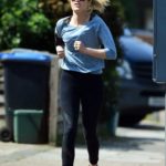 Laura Whitmore in a White Sneakers Enjoys a Jog Out in London