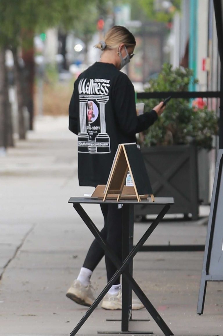 Hailey Bieber in a Black Sweatshirt Stops at Backyard 