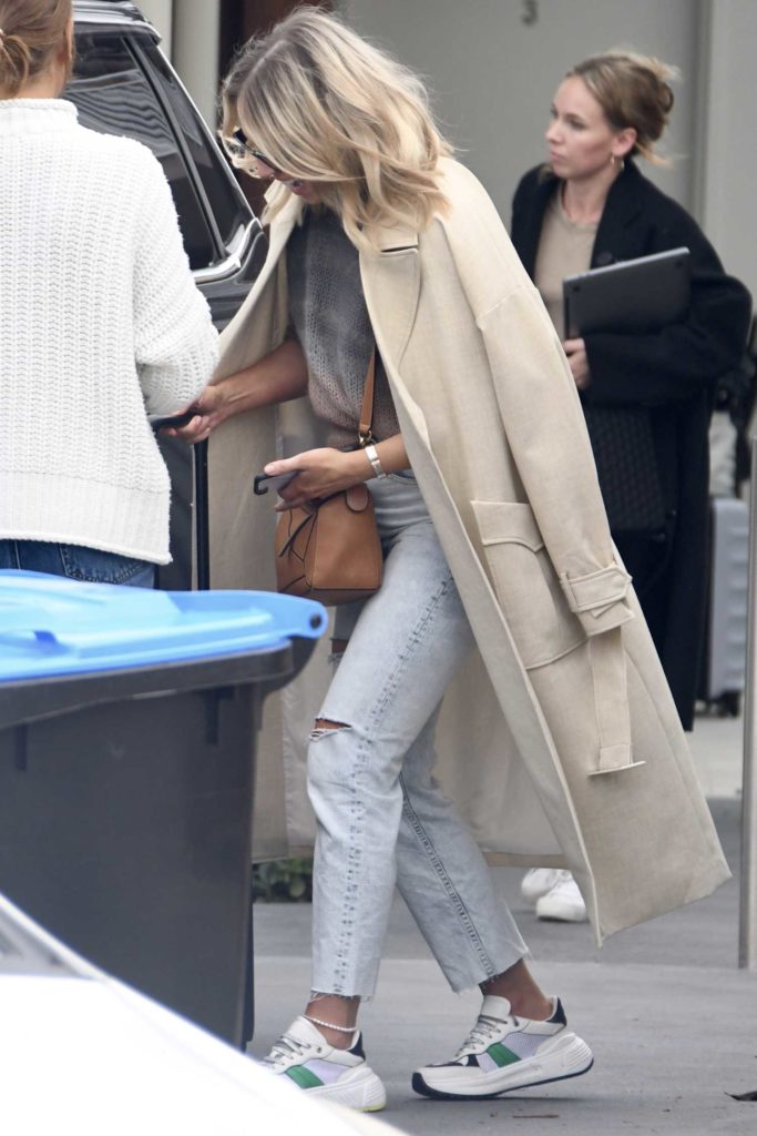 Phoebe Burgess in a Beige Trench Coat