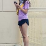 Poppy Drayton in a Purple Tee Checks Her Phone in West Hollywood