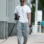 Rachel Lindsay in a White Tee Walks Her Dog in Maimi