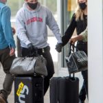 Brooklyn Beckham in a Gray Hoody Out with Nicola Peltz Arrives at JFK Airport in New York