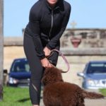 Deborah Hutton in a Red Cap Walks Her Dog in Sydney