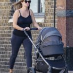Millie Mackintosh in a Black Top Walks Out with Her Daughter Sienna in West London