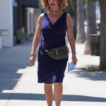 Claudia Wells in a Blue Dress Poses with a DeLorean in Studio City