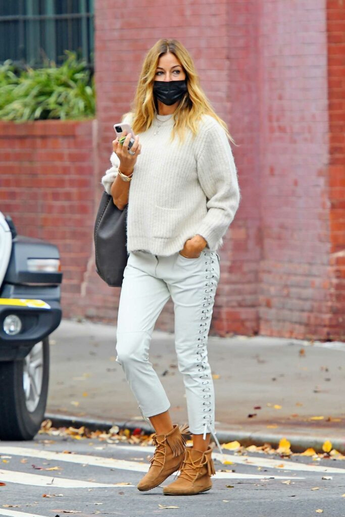 Kelly Bensimon in a Black Protective Mask