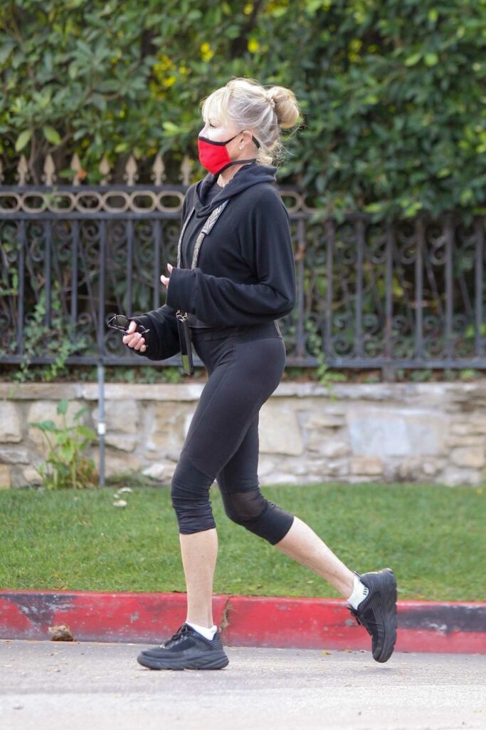 Melanie Griffith in a Red Protective Mask