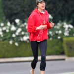 Margaret Qualley in a Red Hoodie Takes Early Morning Jog Out with Shia LaBeouf in Pasadena