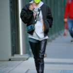 Hunter Schafer in a Neon Green Protective Mask Chats on Her Phone in Soho, New York