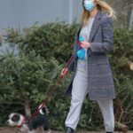 Taylor Neisen in a Grey Beanie Hat Walks Her Dog in New York