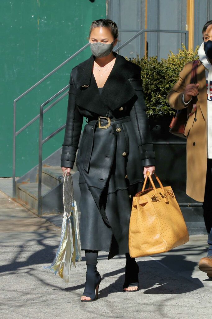 Chrissy Teigen in a Black Leather Coat