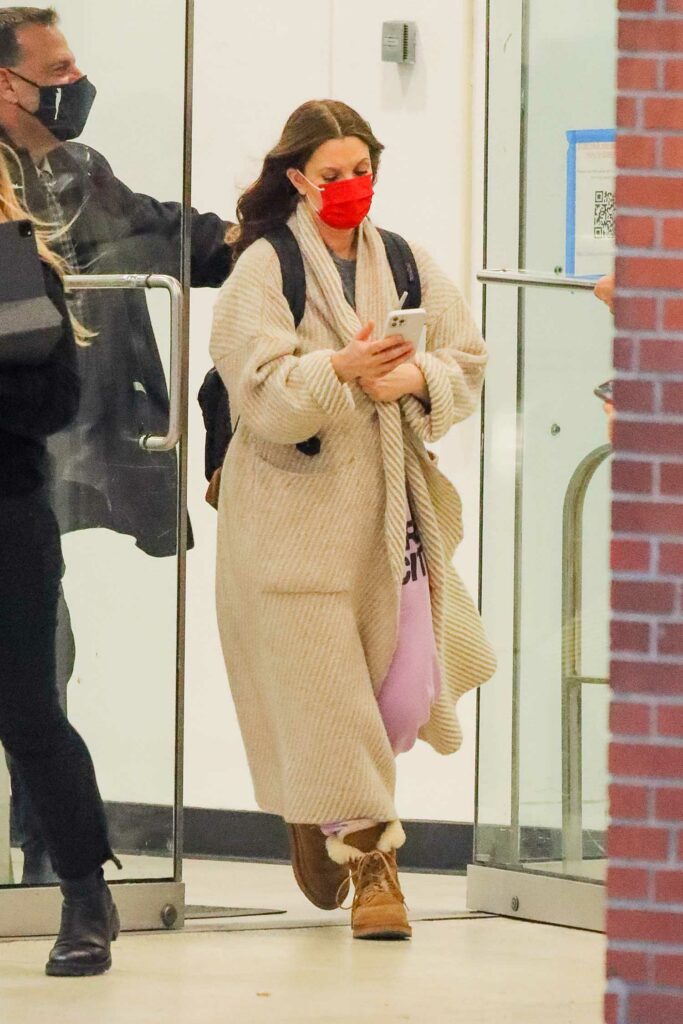 Drew Barrymore in a Red Protective Mask