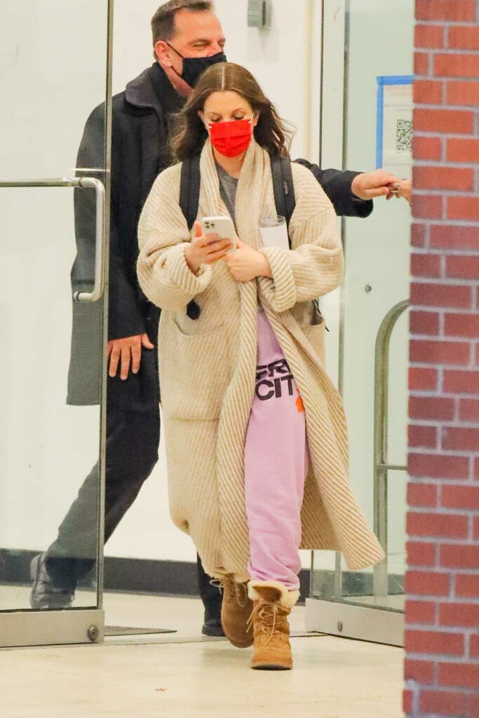 Drew Barrymore in a Red Protective Mask