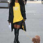 Sinitta in a Yellow Sweatshirt Walks Her Dog in London