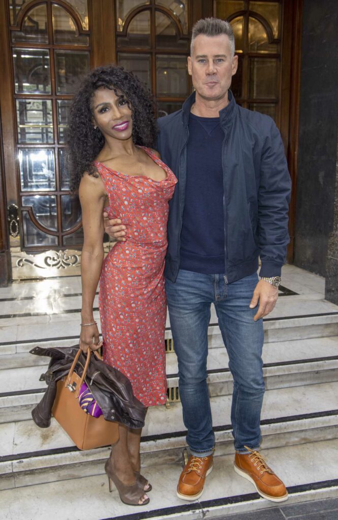 Sinitta in a Red Floral Dress