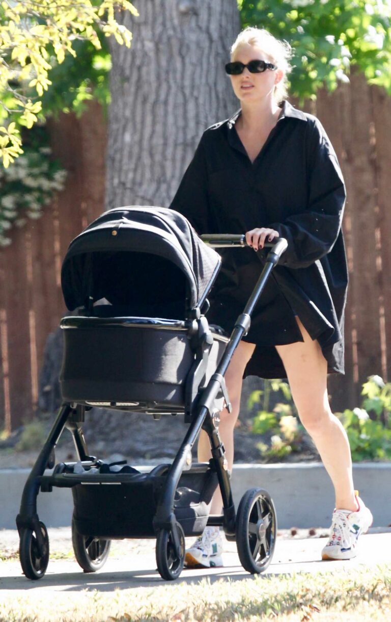 Elsa Hosk in a Black Shirt Goes on a Stroll with Her Daughter in