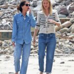 Gwyneth Paltrow in a White Striped Cardigan Takes a Stroll with a Friend on the Beach in Montecito