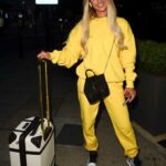 Joanna Chimonides in a Yellow Sweatsuit Arrives in Manchester