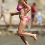 Caprice Bourret in a Pink Bikini on the Beach at the Casa Jondal in Ibiza