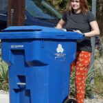 Ariel Winter in a Black Tee Putting Out Her Recycled Trash Can in Los Angeles
