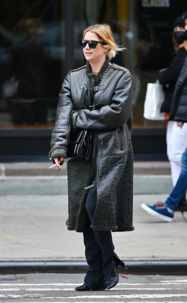 Ashley Benson in a Black Leather Coat