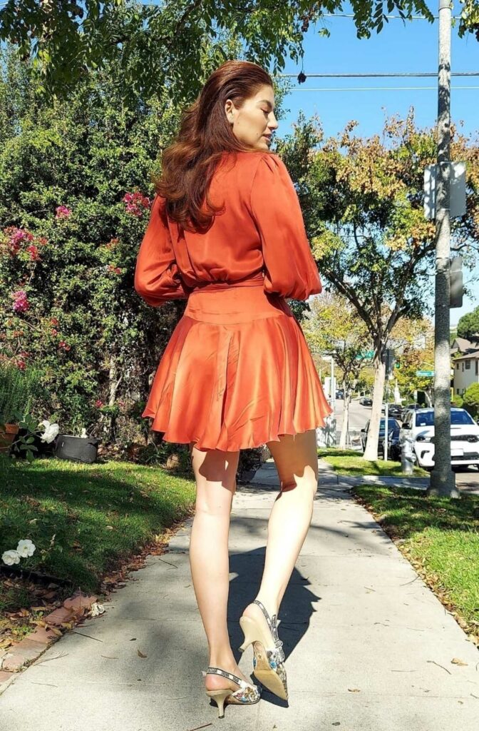 Blanca Blanco in an Orange Mini Dress
