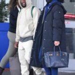 Eniko Parrish in a Black Puffer Coat Arrives at JFK Airport with Kevin Hart in New York