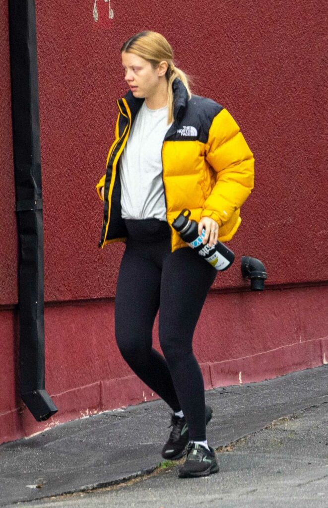 Mia Goth in a Yellow Puffer Jacket