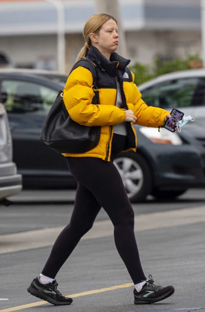 Mia Goth in a Yellow Puffer Jacket