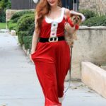 Phoebe Price Dressed as Miss Clause Posing with Her Dog in Los Angeles