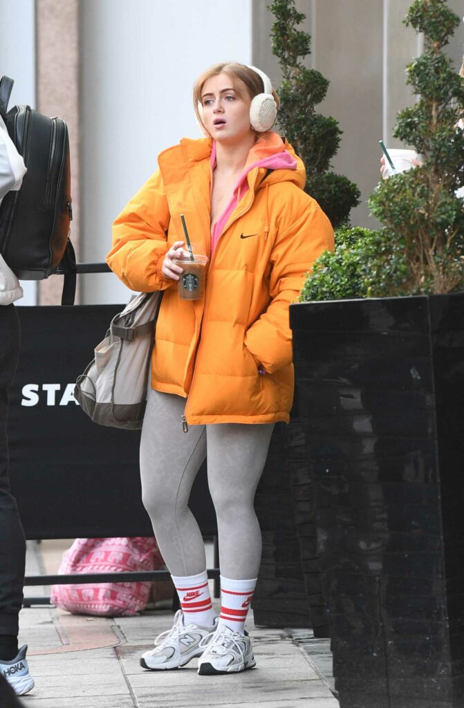 Maisie Smith in an Orange Puffer Jacket