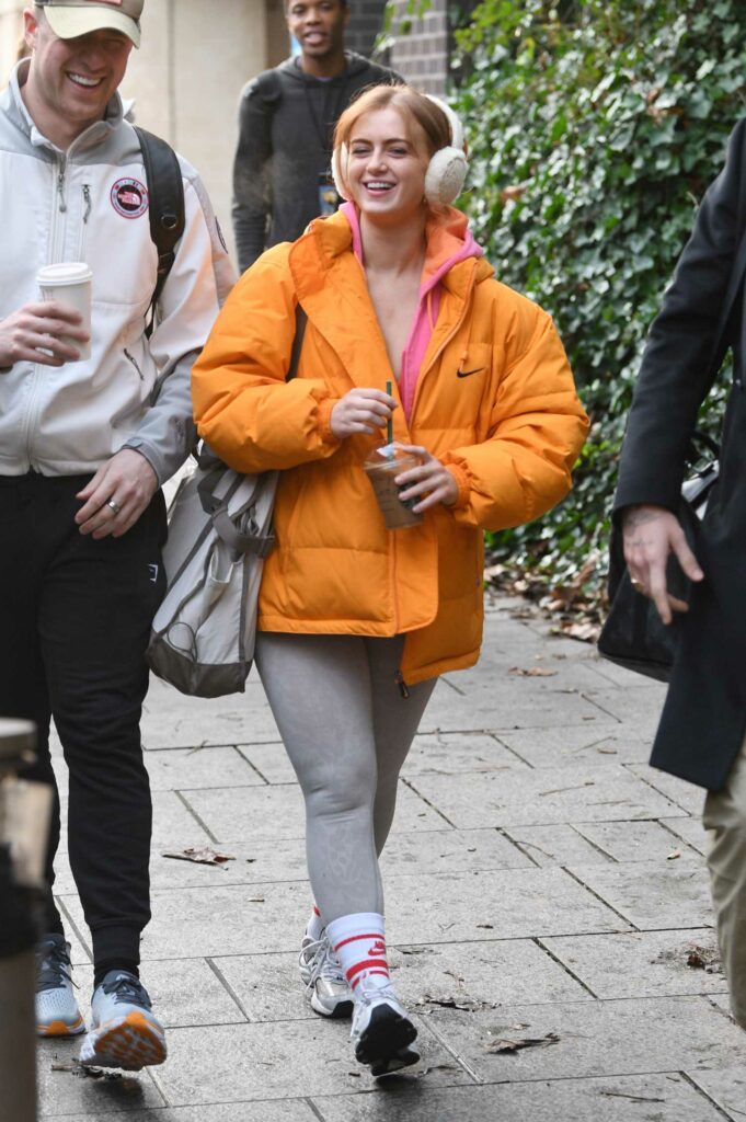 Maisie Smith in an Orange Puffer Jacket