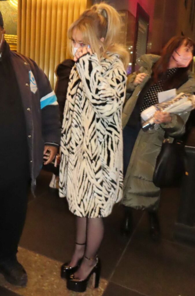 Sabrina Carpenter in a Zebra Print Fur Coat