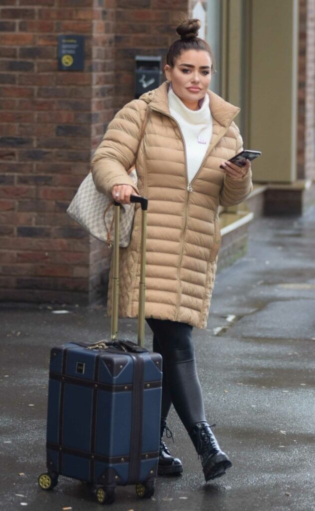 Amy Christophers in a Beige Puffer Coat