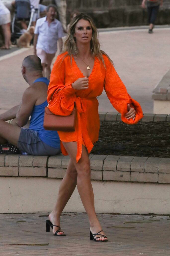 Candice Falzon in an Orange Dress