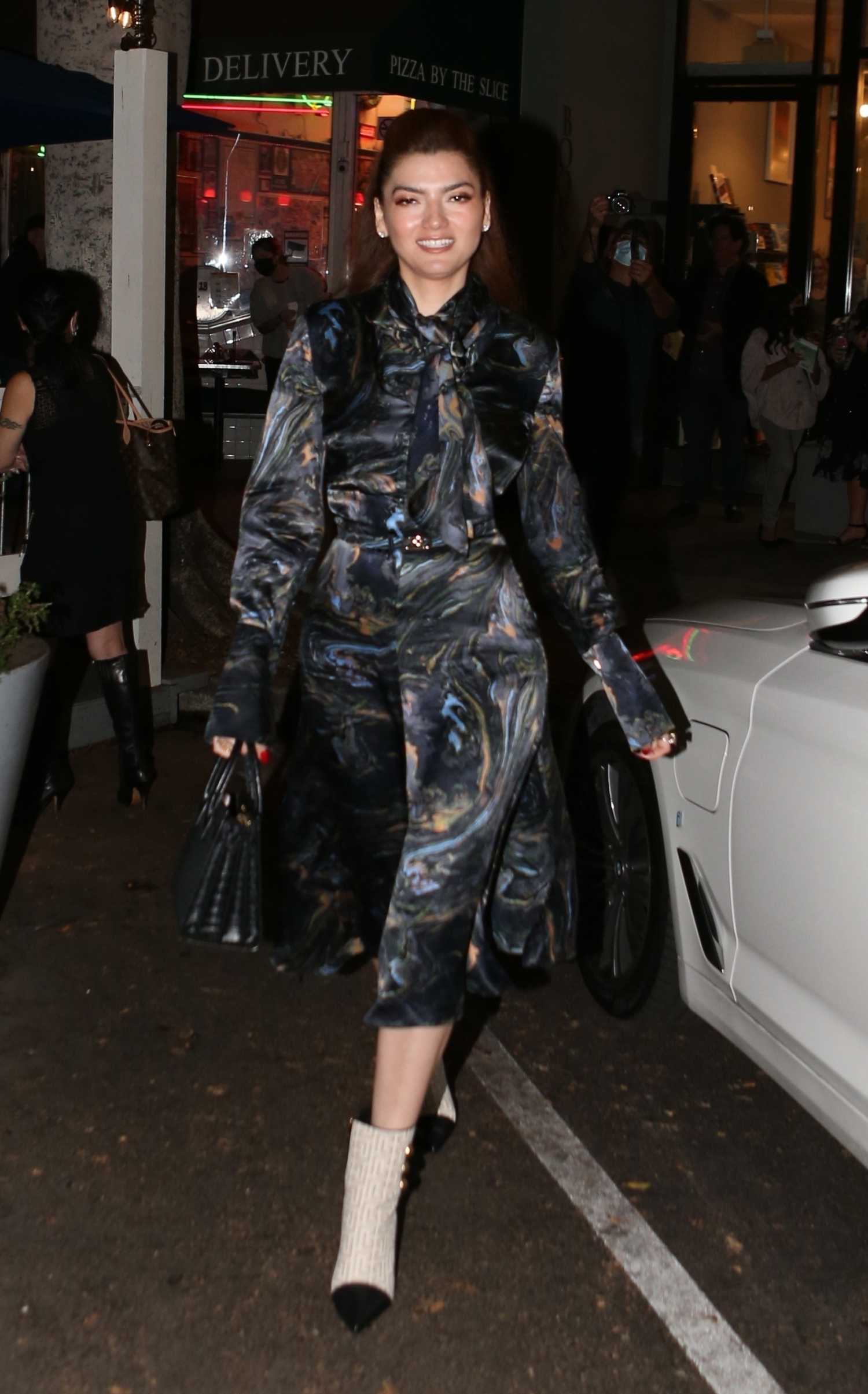 Blanca Blanco in a Colorful Dress Leaves the Chevalier’s Bookstore in