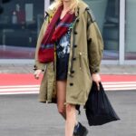 Cara Delevingne in a White Beanie Hat Arrives at Battersea Helipad in London