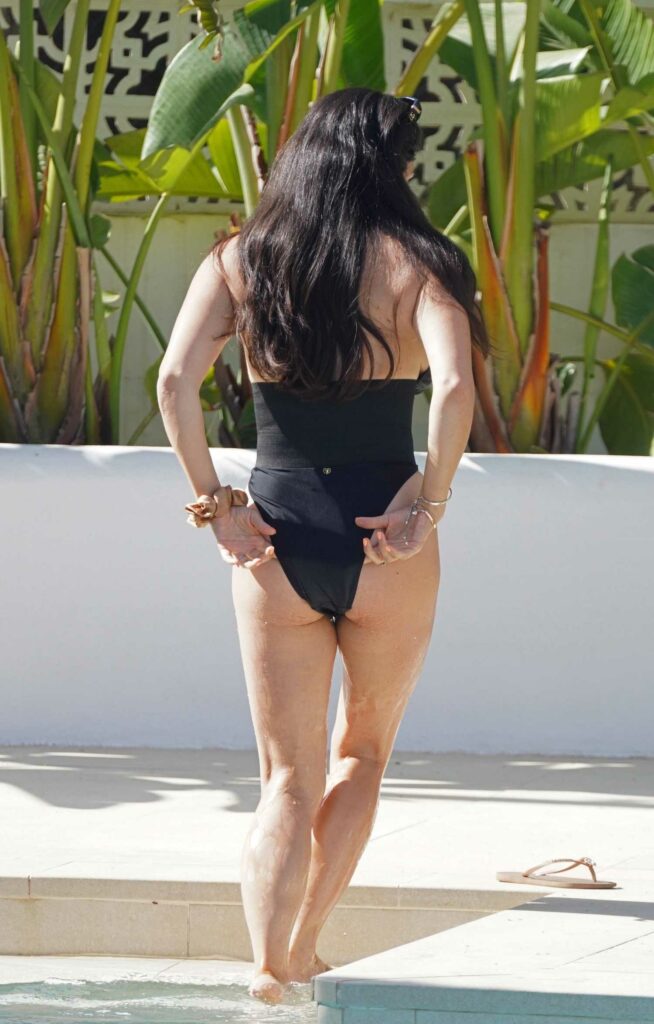 Casey Batchelor in a Black Swimsuit