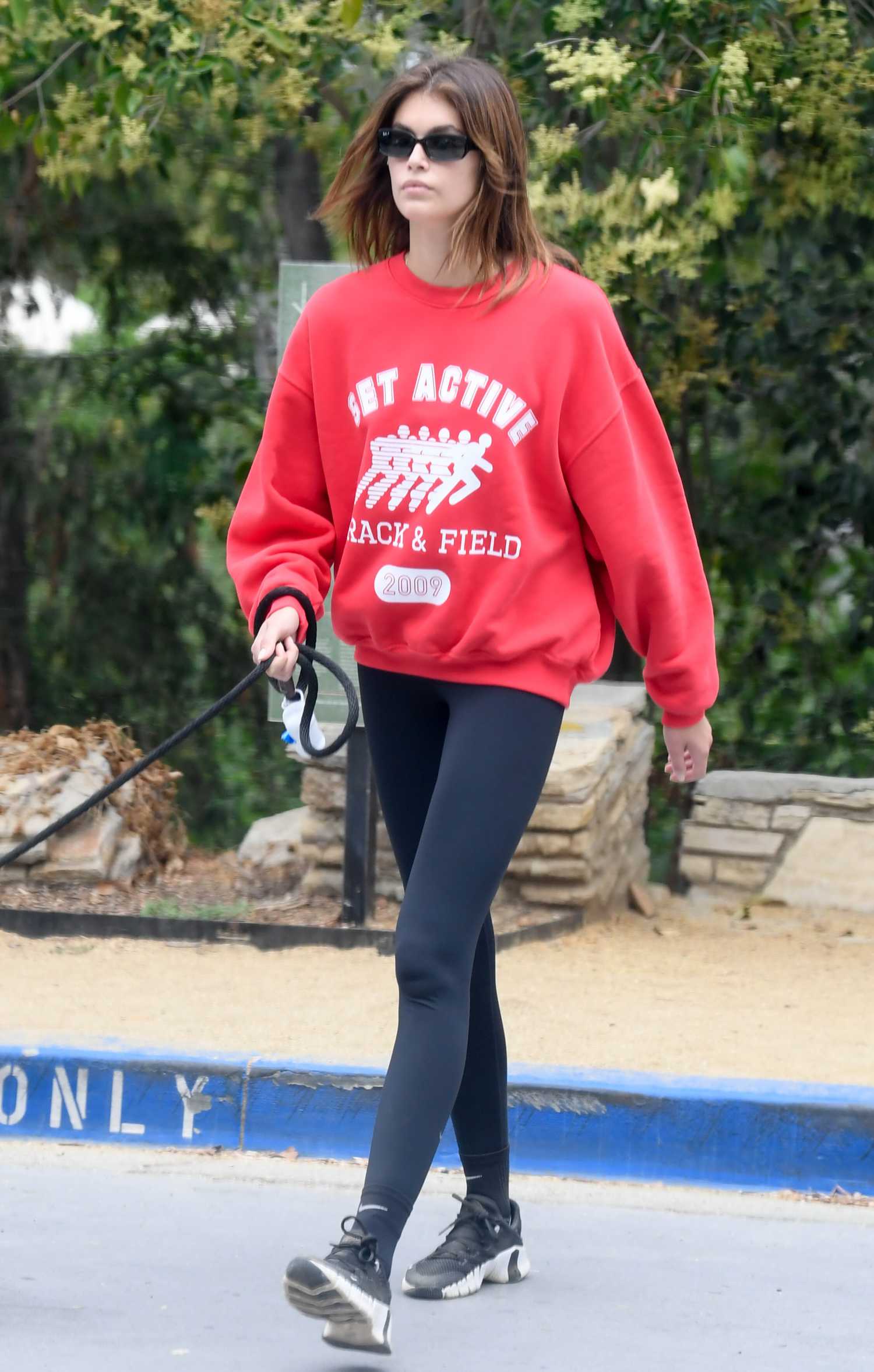 Kaia Gerber in a Red Sweatshirt Takes Her Dog Milo on a Hike in Los