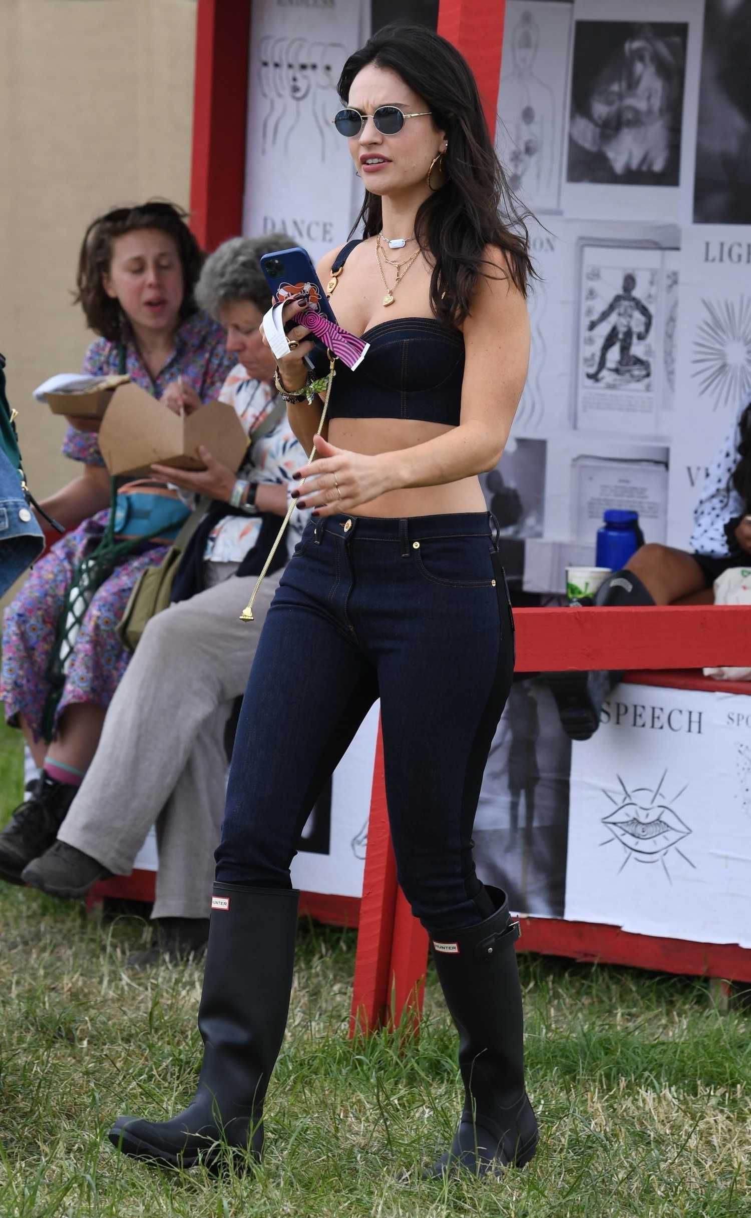 Lily James in a Denim Sports Bra Attends 2022 Glastonbury Music