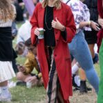 Sienna Miller in a Red Trench Coat Attends 2022 Glastonbury Festival at Worthy Farm in Glastonbury