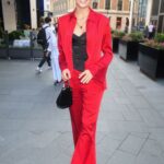 Wallis Day in a Red Pantsuit Attends 2022 BFC / GQ Designer Fashion Fund Winner Announcement at The Londoner Hotel in London