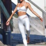 Alessandra Ambrosio in a White Workout Ensemble Was Seen During a Photoshoot on the Beach in Malibu