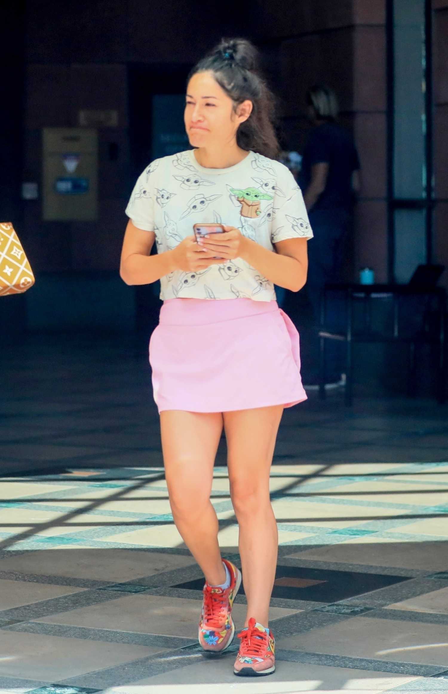 Q’orianka Kilcher in a Pink Mini Skirt Leaves an Office Building in